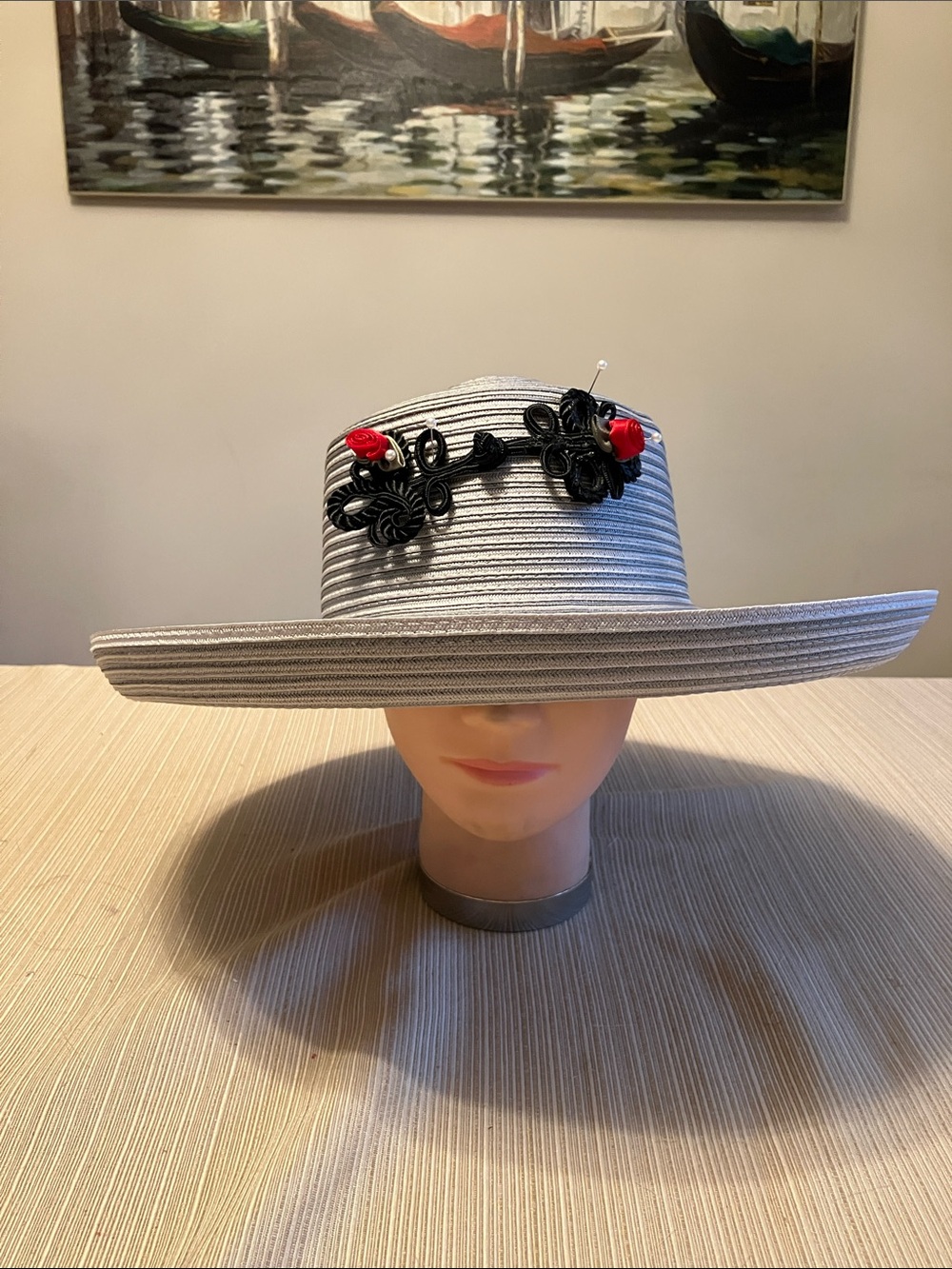Wide Brim Straw Hat with Black Decorative Knot and Red Floral Accent